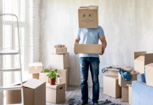 man with box head while packing move